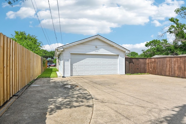 detached garage featuring fence