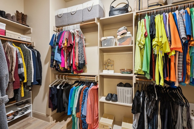 walk in closet featuring wood finished floors