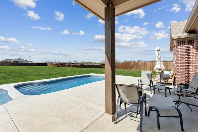 view of swimming pool with a lawn, a fenced backyard, a fenced in pool, and a patio