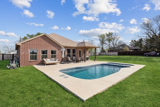 view of swimming pool with a lawn, a patio area, a fenced in pool, and a fenced backyard