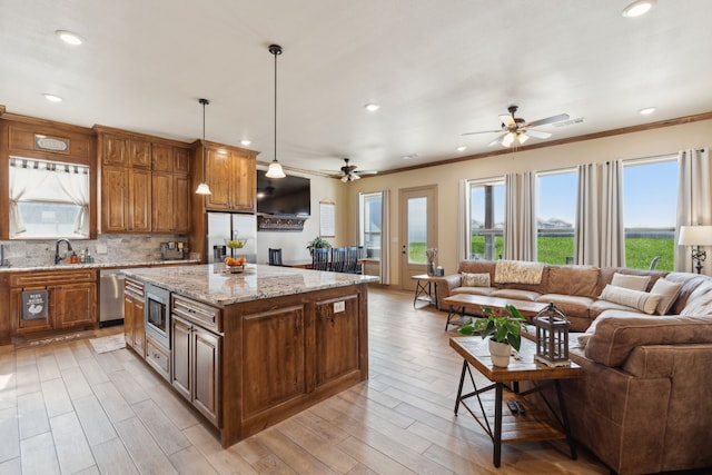 kitchen featuring open floor plan, recessed lighting, stainless steel appliances, and ceiling fan