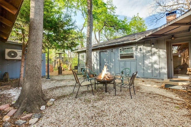 view of patio / terrace featuring ac unit and a fire pit