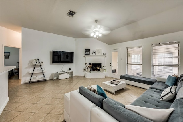 4122 Cory Lee Ct, Arlington, TX 76015 - living room with a ceiling fan, light tile patterned floors, vaulted ceiling, and a fireplace with raised hearth