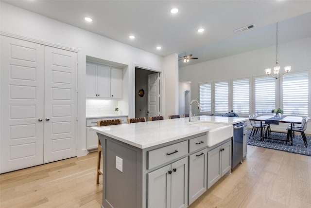 1716 Bradford Pear Way, Celina, TX 75078 - kitchen with a sink, ceiling fan, dishwasher, light wood-style floors, and a chandelier