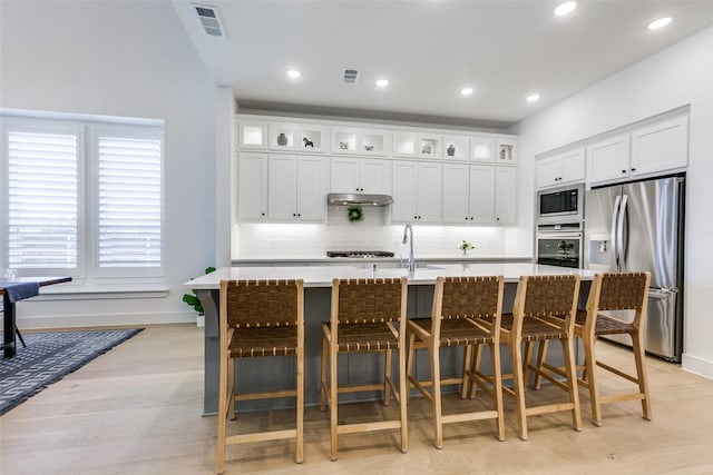 1716 Bradford Pear Way, Celina, TX 75078 - kitchen featuring stainless steel appliances, baseboards, backsplash, light countertops, and a kitchen breakfast bar