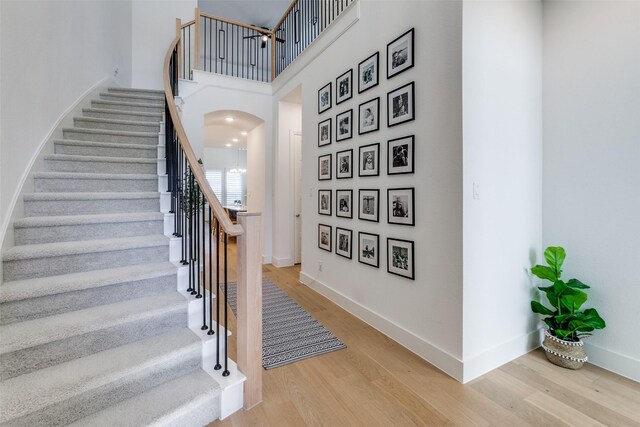 1716 Bradford Pear Way, Celina, TX 75078 - stairs with wood finished floors, arched walkways, baseboards, and a high ceiling