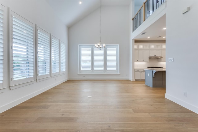 1716 Bradford Pear Way, Celina, TX 75078 - unfurnished dining area with high vaulted ceiling, a chandelier, baseboards, and light wood-style flooring
