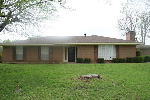 single story home featuring brick siding and a front lawn