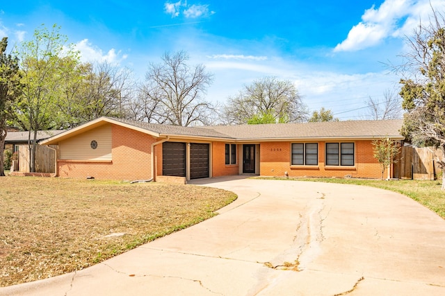 ranch-style home featuring brick siding, driveway, and an attached garage