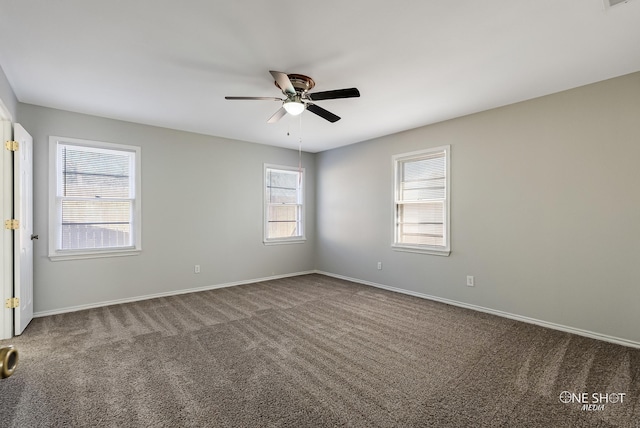 unfurnished room with carpet flooring, a ceiling fan, and baseboards