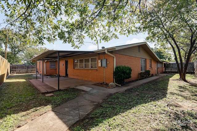 view of home's exterior with a patio area, brick siding, and a fenced backyard