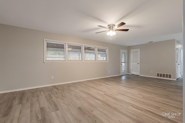 unfurnished living room featuring ceiling fan, wood finished floors, and baseboards