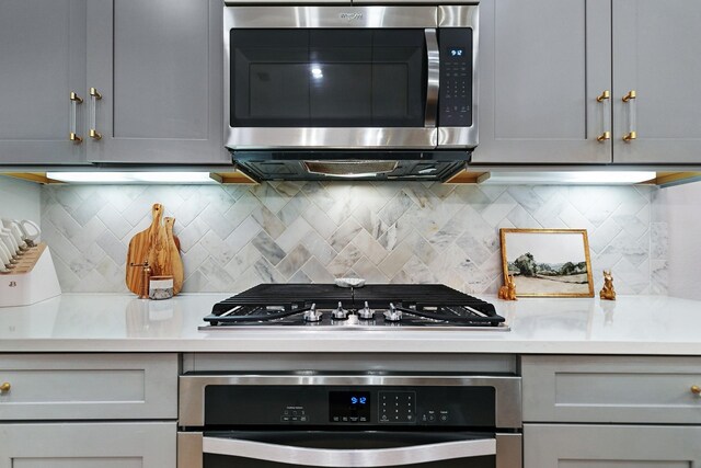 5108 Shallow Pond Dr, Little Elm, TX 76227 - kitchen with appliances with stainless steel finishes, gray cabinetry, and light countertops