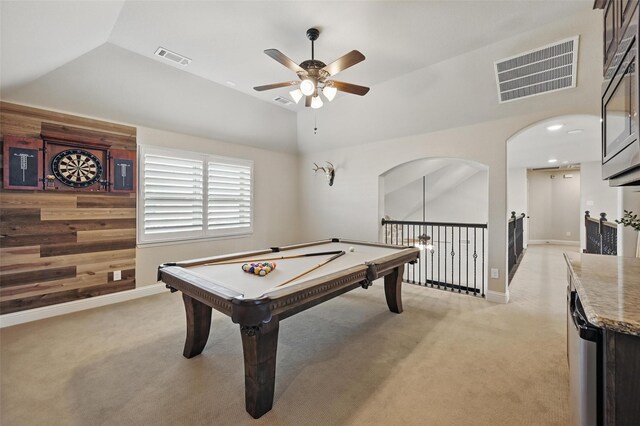 playroom featuring light carpet, vaulted ceiling, visible vents, and a ceiling fan