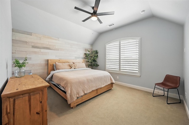 bedroom featuring lofted ceiling, baseboards, ceiling fan, visible vents, and light carpet