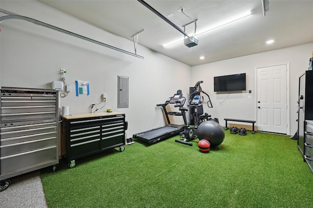 exercise area featuring dark carpet, recessed lighting, a garage, and electric panel
