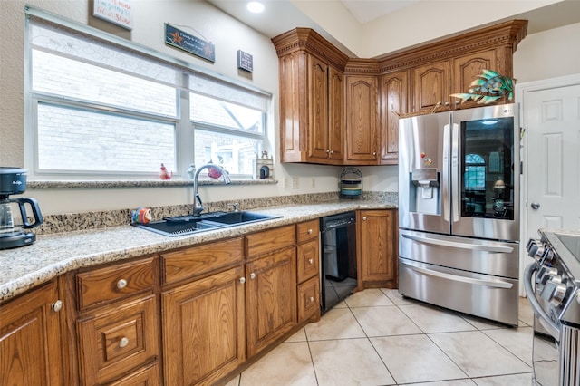 1207 Stafford St, Dallas, TX 75208 - kitchen with stainless steel appliances, a sink, brown cabinets, and light tile patterned floors