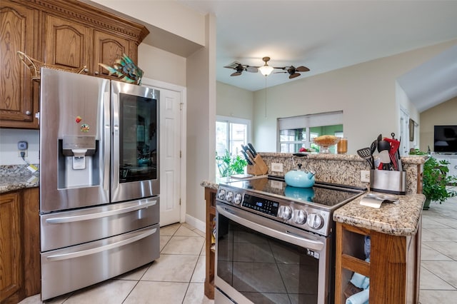 1207 Stafford St, Dallas, TX 75208 - kitchen featuring stainless steel appliances, brown cabinetry, and light stone counters