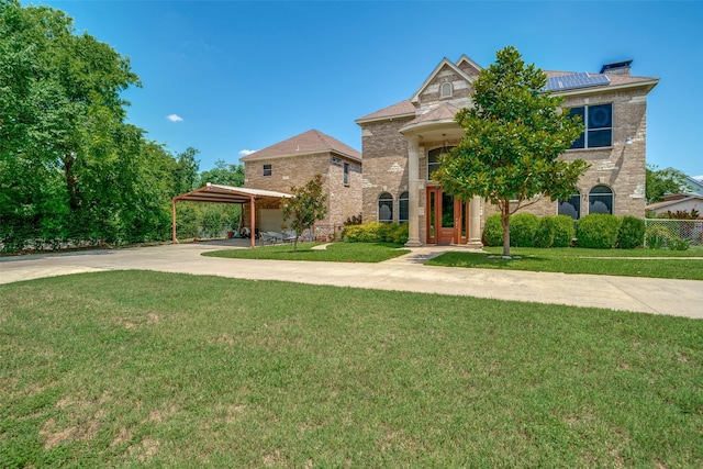 1207 Stafford St, Dallas, TX 75208 - view of front of property featuring driveway, solar panels, a front lawn, and brick siding