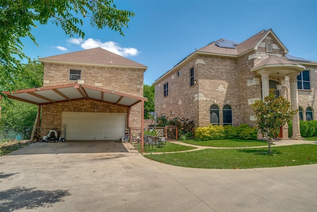 1207 Stafford St, Dallas, TX 75208 - view of home's exterior featuring brick siding, roof mounted solar panels, driveway, and a yard