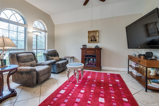 1207 Stafford St, Dallas, TX 75208 - living room featuring lofted ceiling, light tile patterned flooring, ceiling fan, a glass covered fireplace, and baseboards