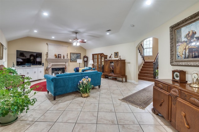 1207 Stafford St, Dallas, TX 75208 - living area featuring lofted ceiling, a ceiling fan, light tile patterned flooring, a glass covered fireplace, and stairs