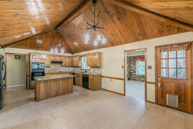 2111 Meadowview Dr, Keller, TX 76262 - kitchen featuring baseboards, under cabinet range hood, a sink, and black appliances
