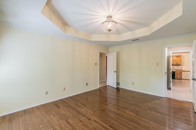 2111 Meadowview Dr, Keller, TX 76262 - empty room featuring a raised ceiling, wood finished floors, visible vents, baseboards, and a chandelier