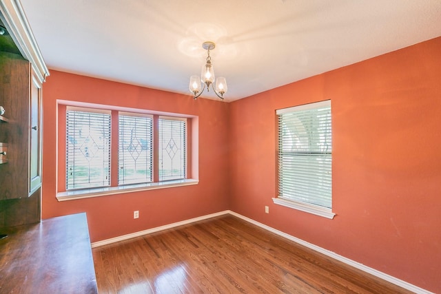 2111 Meadowview Dr, Keller, TX 76262 - unfurnished room with a notable chandelier, baseboards, a healthy amount of sunlight, and wood finished floors