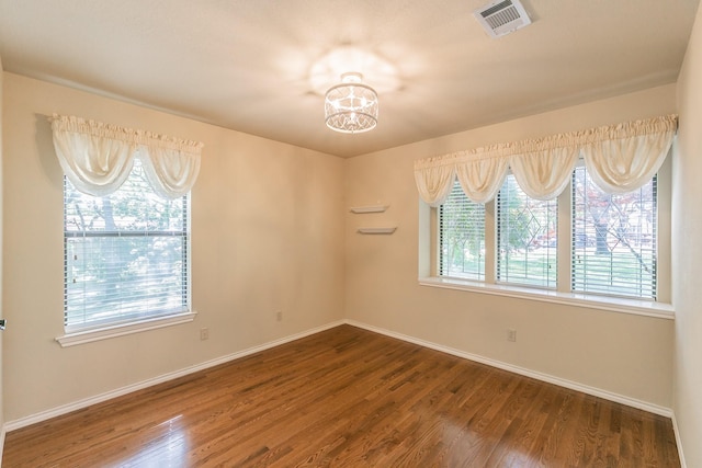 2111 Meadowview Dr, Keller, TX 76262 - unfurnished room featuring wood finished floors, visible vents, baseboards, and an inviting chandelier