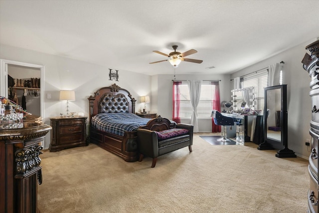 bedroom with light carpet and a ceiling fan