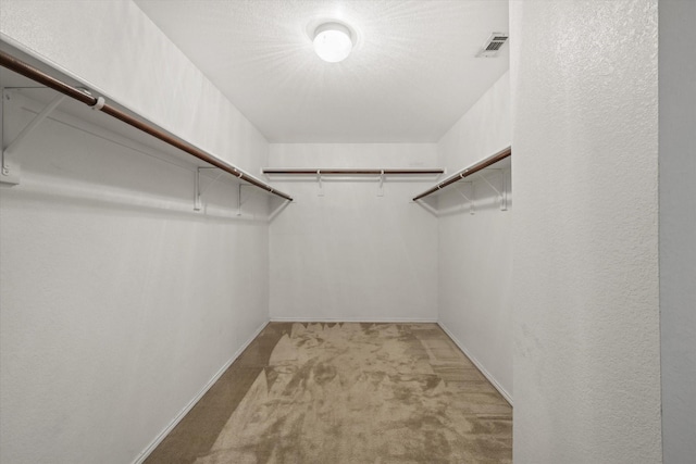spacious closet featuring visible vents and carpet