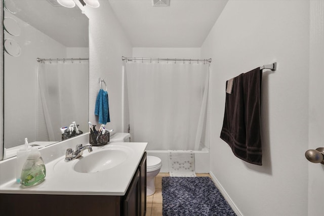 bathroom with tile patterned flooring, shower / tub combo, toilet, and vanity