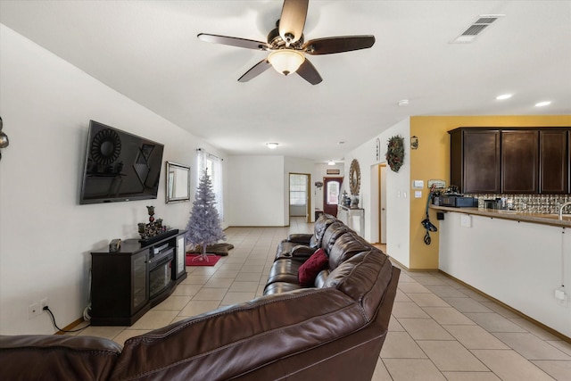 living room with a ceiling fan, visible vents, recessed lighting, and light tile patterned floors