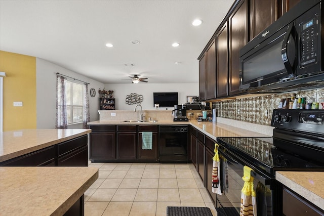 kitchen featuring a ceiling fan, dark brown cabinets, a sink, black appliances, and light countertops