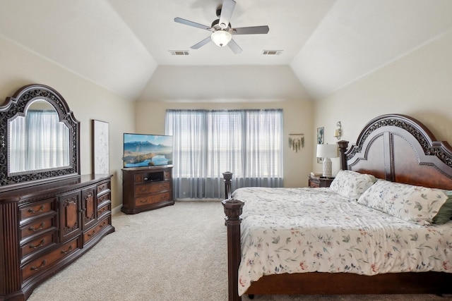 bedroom with ceiling fan, visible vents, vaulted ceiling, and light colored carpet