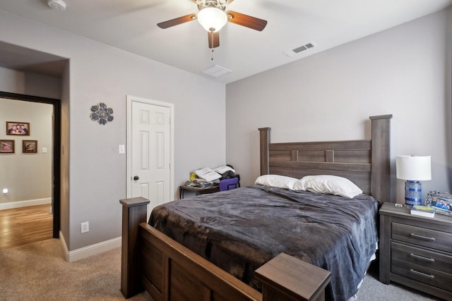 bedroom with ceiling fan, baseboards, light colored carpet, and visible vents