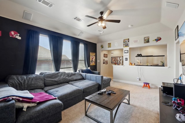 carpeted living area featuring baseboards, ceiling fan, and visible vents