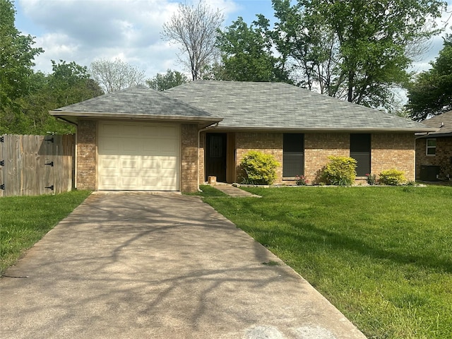 ranch-style home featuring concrete driveway, a front yard, central AC, a garage, and fence