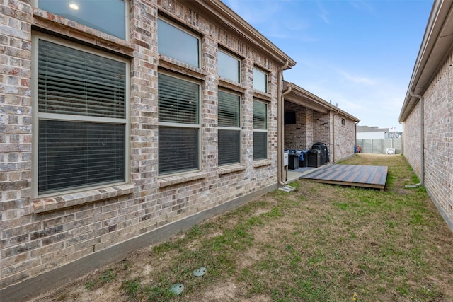 view of home's exterior with a yard and fence