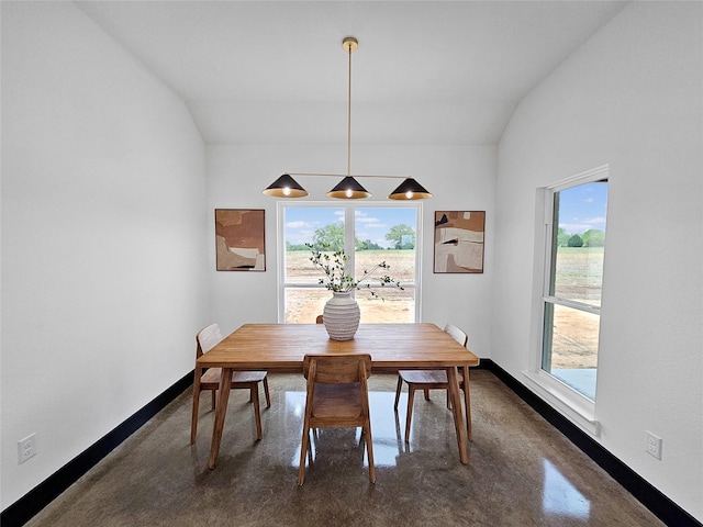 dining room with plenty of natural light, finished concrete floors, and baseboards
