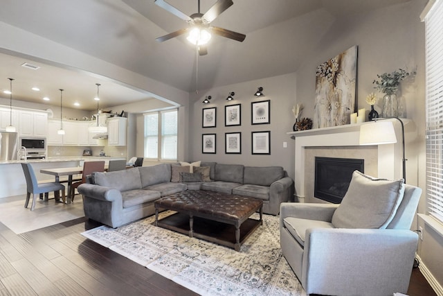 living room featuring visible vents, a ceiling fan, a fireplace, recessed lighting, and wood finished floors
