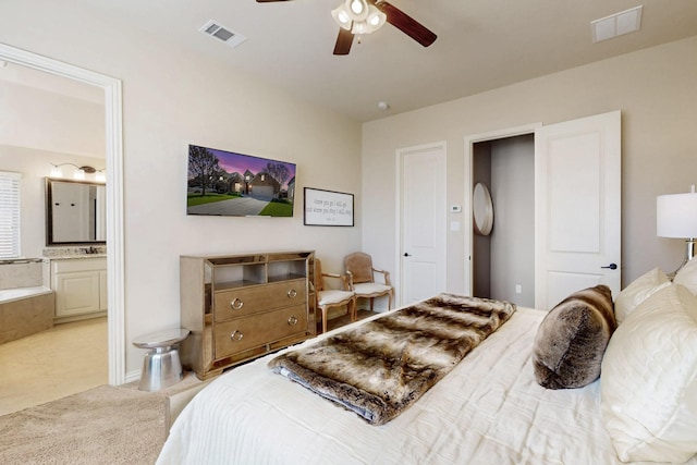carpeted bedroom featuring ensuite bathroom, ceiling fan, and visible vents