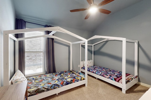 carpeted bedroom with vaulted ceiling and a ceiling fan