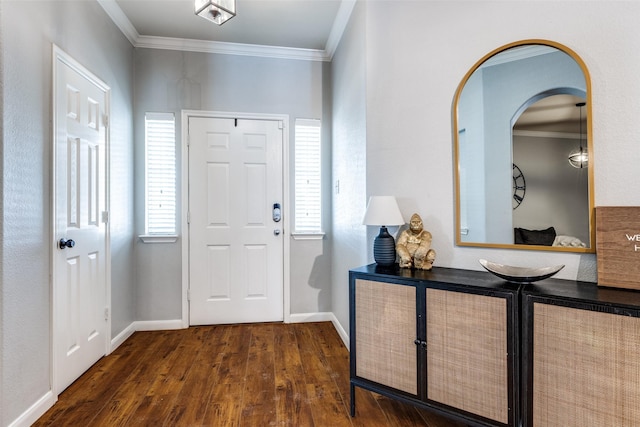 foyer entrance featuring dark wood-type flooring, arched walkways, baseboards, and ornamental molding
