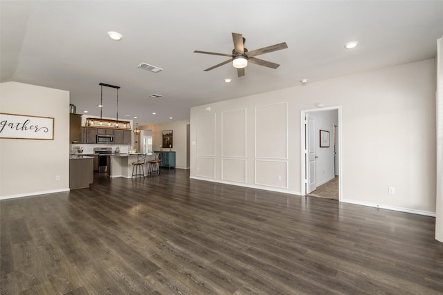unfurnished living room with recessed lighting, visible vents, dark wood-style flooring, and a ceiling fan