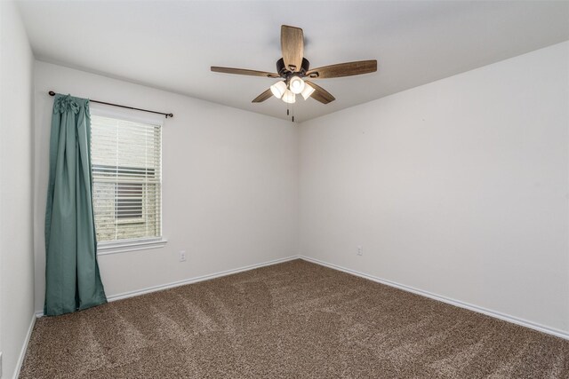 empty room featuring baseboards, a ceiling fan, and carpet flooring