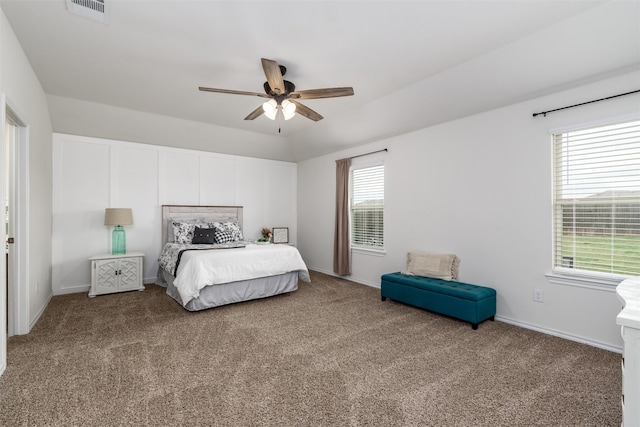 bedroom featuring visible vents, baseboards, ceiling fan, and carpet