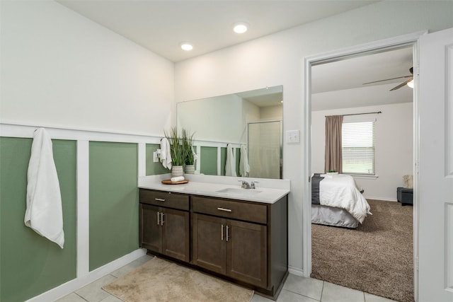 bathroom featuring vanity, a stall shower, tile patterned floors, ensuite bathroom, and ceiling fan
