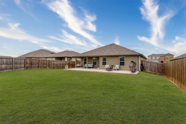 rear view of house featuring a patio area, a yard, and a fenced backyard